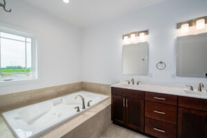 bathtub and vanity with Jack and Jill sinks
