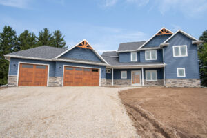 exterior of blue home with double garage